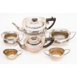 An Edwardian silver three piece tea service comprising teapot,
