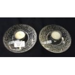 A pair of orrefors oval form candle stands, the undersides rusticated,