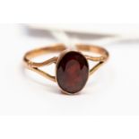 A 9ct rose gold and faceted garnet ring, open shoulders, size T, total gross weight approx 2.