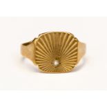 A 9ct gold Gentleman's signet ring, radiating ground set with a small white stone, size O,