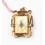 A Masonic gold plated locket with abalone shell detail