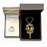 A cabochon crysoberyl set in key pattern silver frame, together with a large citrine, pearl,