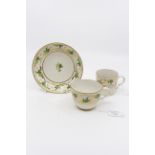 A Pinxton trio, pattern 312, including coffee can, saucer and tea cup, decorated in gold and green,