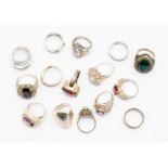 A collection of fifteen silver and white metal dress rings, some stone set,