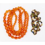 Two strands of plastic amber tone beads along with a vintage enamel multicoloured bead necklace (3)