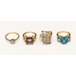 A collection of four 9ct gold stone set dress rings, including a diamond set flower cluster,