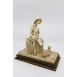 An Italian figurine of a girl on a packing case, dockside, in alabaster resin,