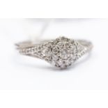 A diamond cluster ring, round tiered cluster with diamond set shoulders, 9ct white gold, size S,