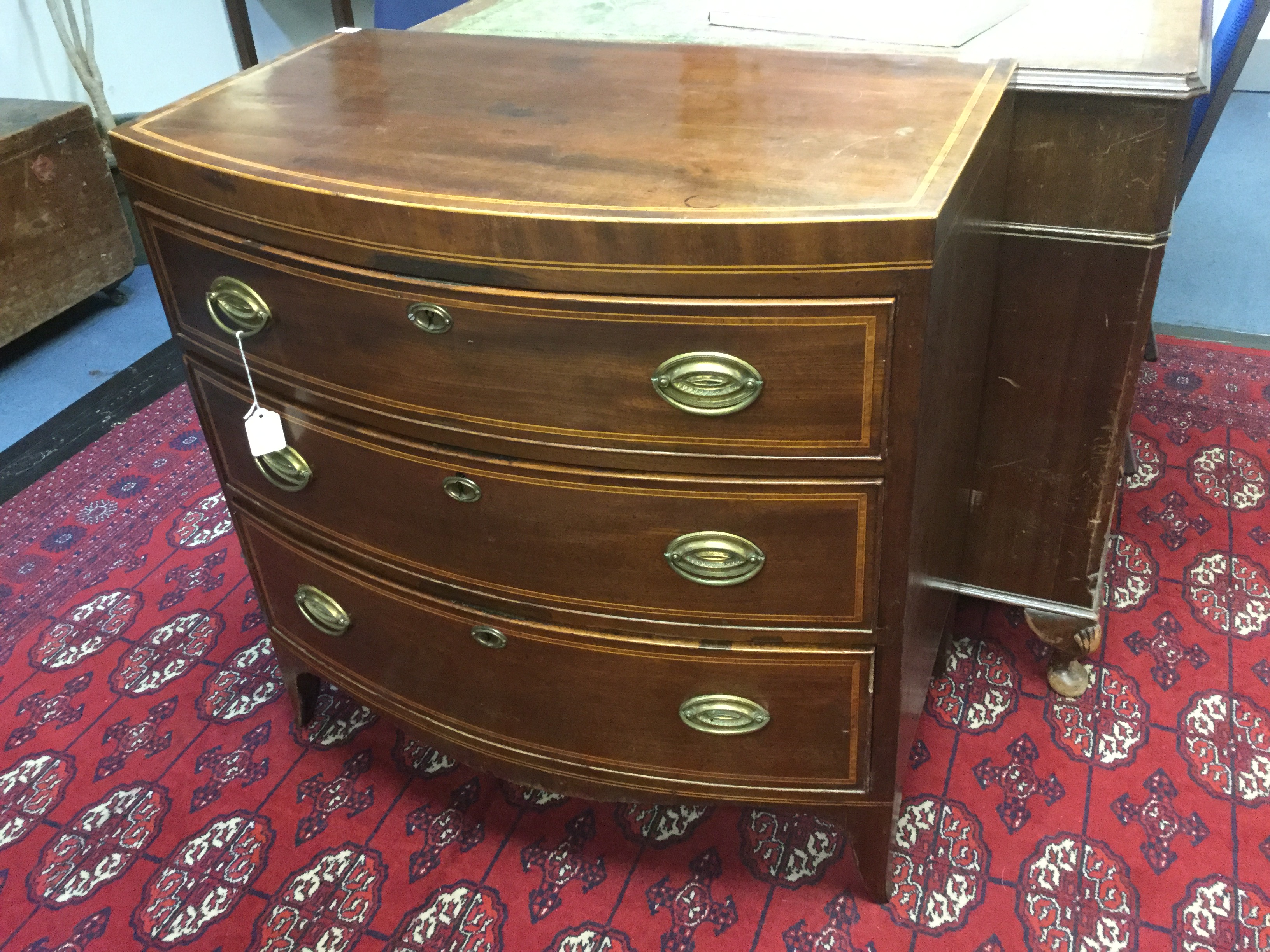 A George III mahogany bow fronted chest of drawers, fitted with three graduated drawers, - Image 2 of 2