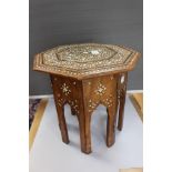 An Indian hand made side table with inlaid Ivory forming a decorative floral pattern,