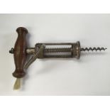 A 19th Century pillar corkscrew with side brush together with two various bottle stoppers,