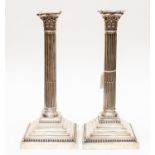 A pair of George V Corinthian column candlesticks, the base engraved with initials, Cooper Brothers,