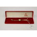 A Tudor Royal, 9ct gold ladies watch, champagne round dial, batons and numbers,