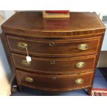 A George III mahogany bow fronted chest of drawers, fitted with three graduated drawers,