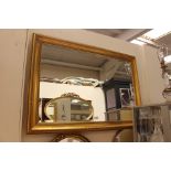 A large gilt framed mirror.