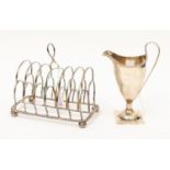 A George III silver seven bar toast rack, segmented arcading, gadroon border and squat ball feet,