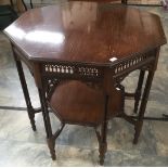 An Edwardian mahogany octagonal two tier occasional table, Gothic pierced gallery to Frieze,
