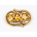 A Victorian gilt metal and three stone citrine coloured glass brooch, size approx 60 mm x 35 mm,