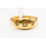 An 18ct gold and diamond set ring, set with three small diamonds, size M,