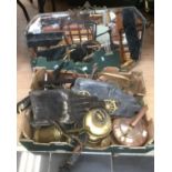 A collection of horse brasses, copper kettles, iron items including a mirror.