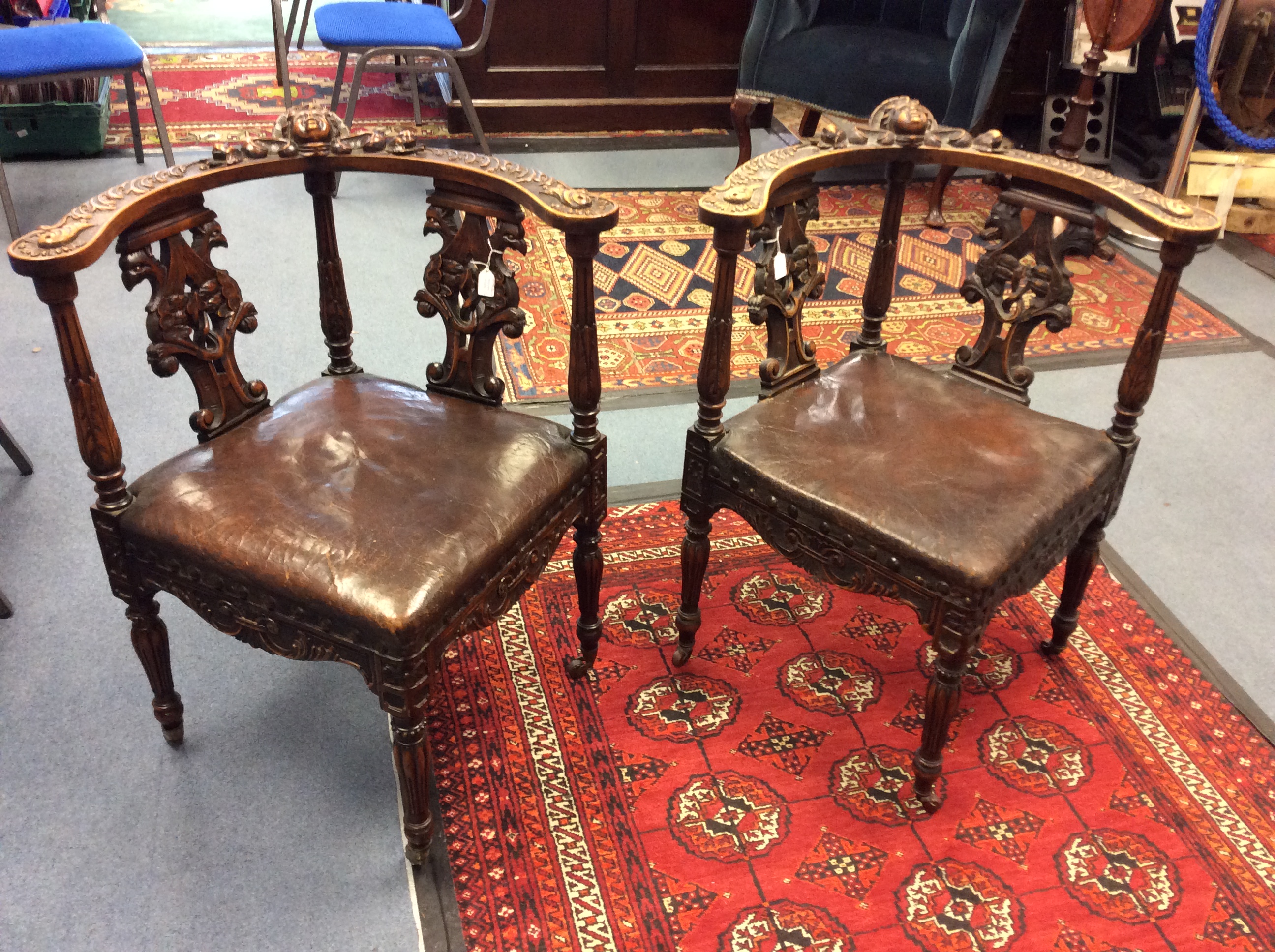 A pair of late 19th Century hand carved corner chairs, mahogany, with carved back splats,