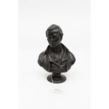 A mid 19th Century Wedgwood black basalt bust of Robert Burns, mounted on a black basalt soccle,