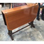 A late 19th Century mahogany Sutherland table, raised on turned supports,