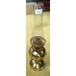 A Brass Oil Lamp complete with clear glass shade. 49cm in height.
