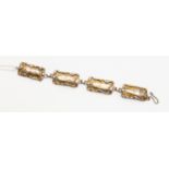 A silver bracelet with rectangular links with reticulated edges, shepherds hook clasp,