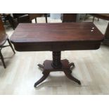 An early Victorian mahogany pedestal fold over tea table