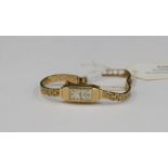 A ladies 9ct gold Rotary bracelet watch, elongated dial, width approx 10 mm, textured bracelet,