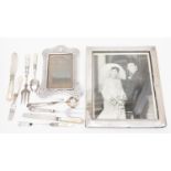 A silver photo frame, white metal frame silver, weighted handles mother of pearl handles,