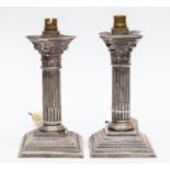 A pair of George V silver Corinthian column electrical candlesticks converted to lamp bases,