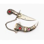 A continental silver and paste set sword and case brooch, set with red and pink coloured paste,