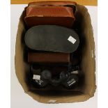 Two pairs of binoculars,together with various leather cased shaving sets and cigarette covers.