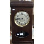 A George V oak eight day wall hanging box clock with a silvered dial and black Arabic numerals