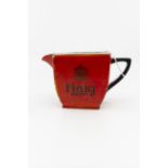 A Carlton Ware Haig whisky jug, early 20th Century, black decoration on a red ground,