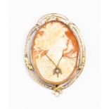 A 14ct gold oval shell cameo, the carved bust figure set with a small diamond,