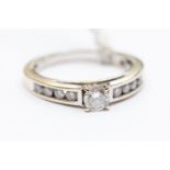 An 18ct white gold and diamond ring, centre claw set stone approx 0.