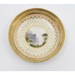 A Derby tea cup and saucer, apricot ground and overlaid with gilding a Vandyke border,