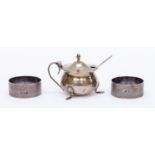 Two silver Birmingham 1920 napkin rings, cauldron style silver mustard pot,