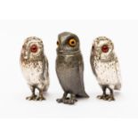 A pair of Victorian silver novelty pepperettes in the form of standing owls,