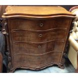 A Reproduction serpentine walnut chest of drawers, fitted with four graduated drawers,
