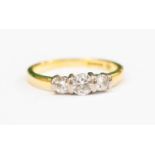 A diamond three stone 18 ct gold ring,