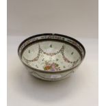 A 19th Century Chinese export armorial punch bowl, decorated with swags of flowers,