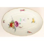 A Meissen oval side dish with altozier relief, a bouquet of flowers and strewn flowers, gilt rim,