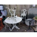 A pair of cast metal white painted garden tables, a pair of cast iron white painted chairs,