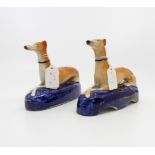 A pair of late Victorian Staffordshire greyhound figural pen stands (2)