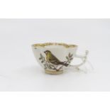 A Meissen shaped teacup depicting a bird on a branch, gilded rim, marked to base.