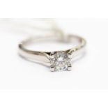 A diamond solitaire, claw set 18ct white gold ring,